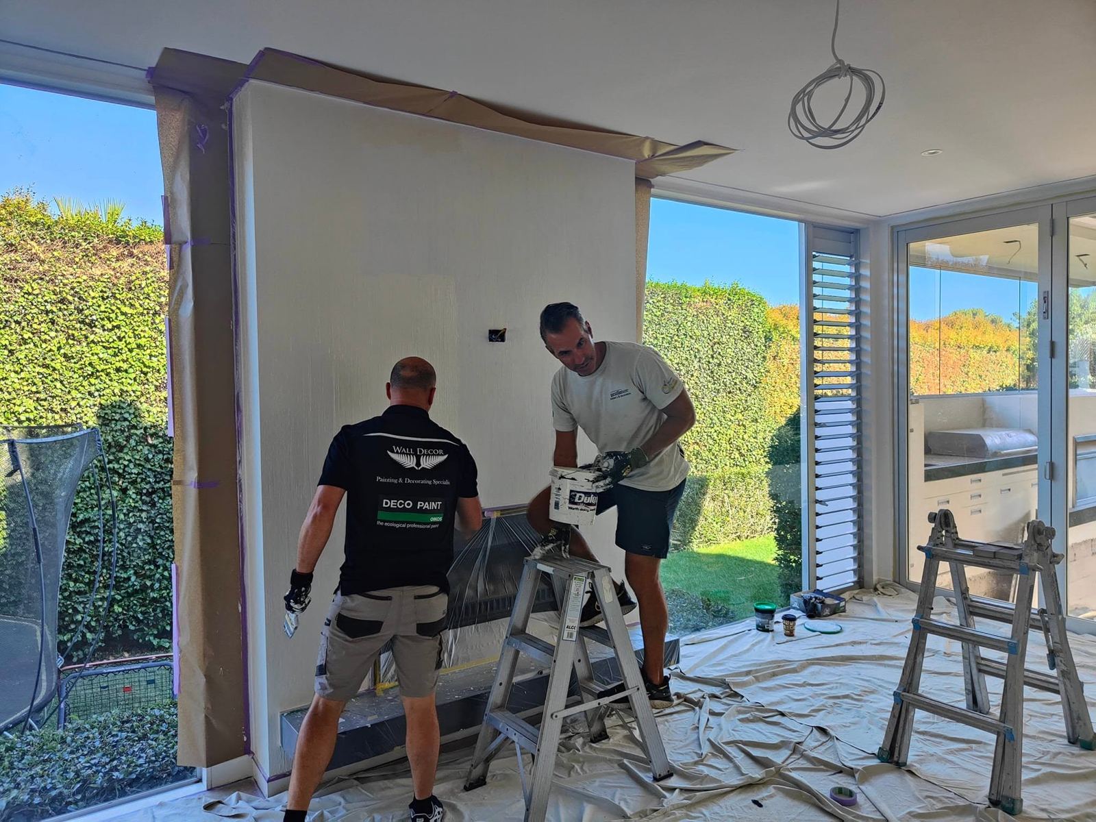 The Wall Decor team preparing a fireplace wall for a decorative finish